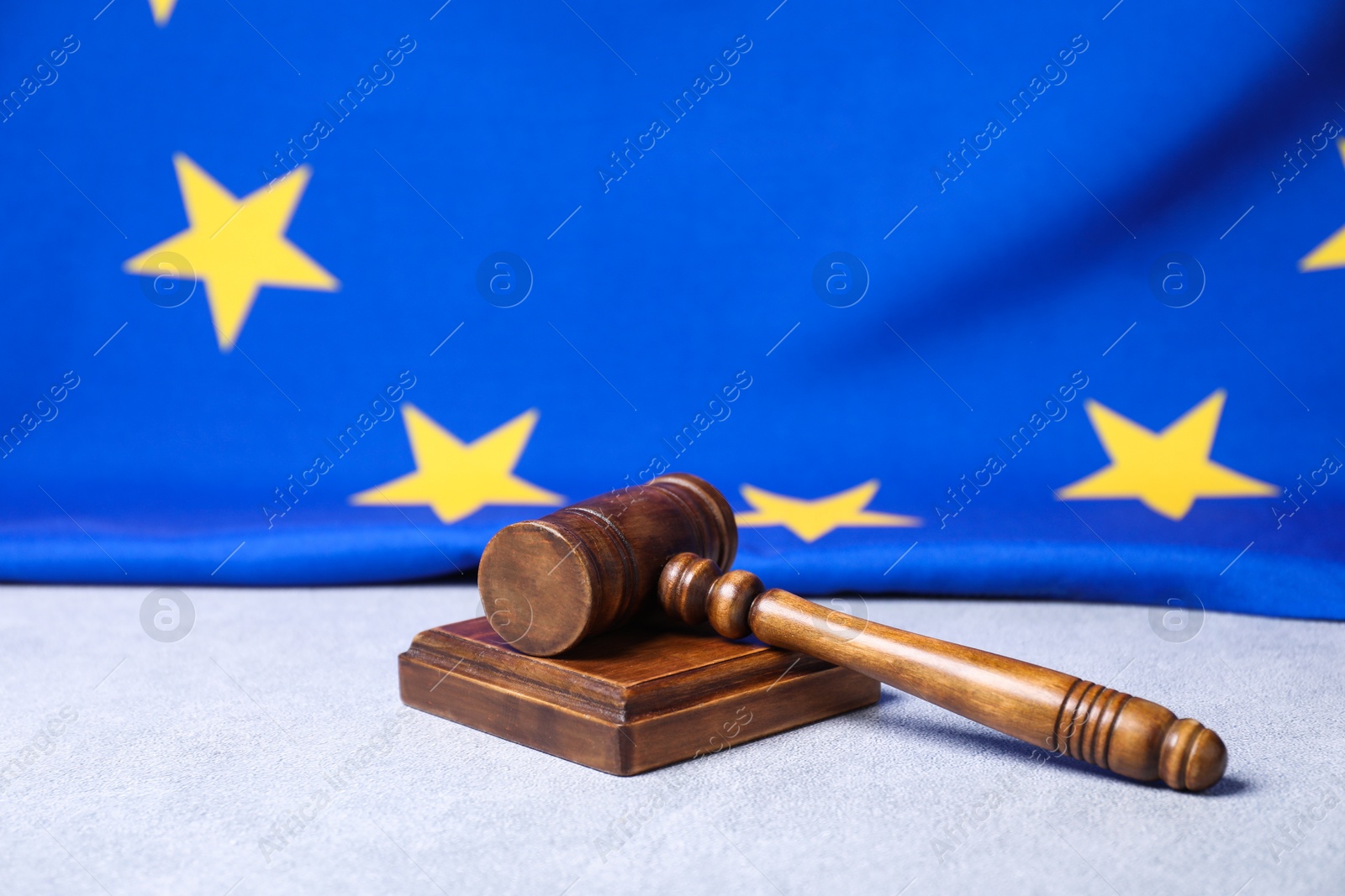 Photo of Judge's gavel and European Union flag on light grey table