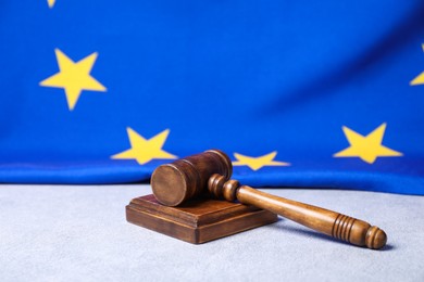 Photo of Judge's gavel and European Union flag on light grey table