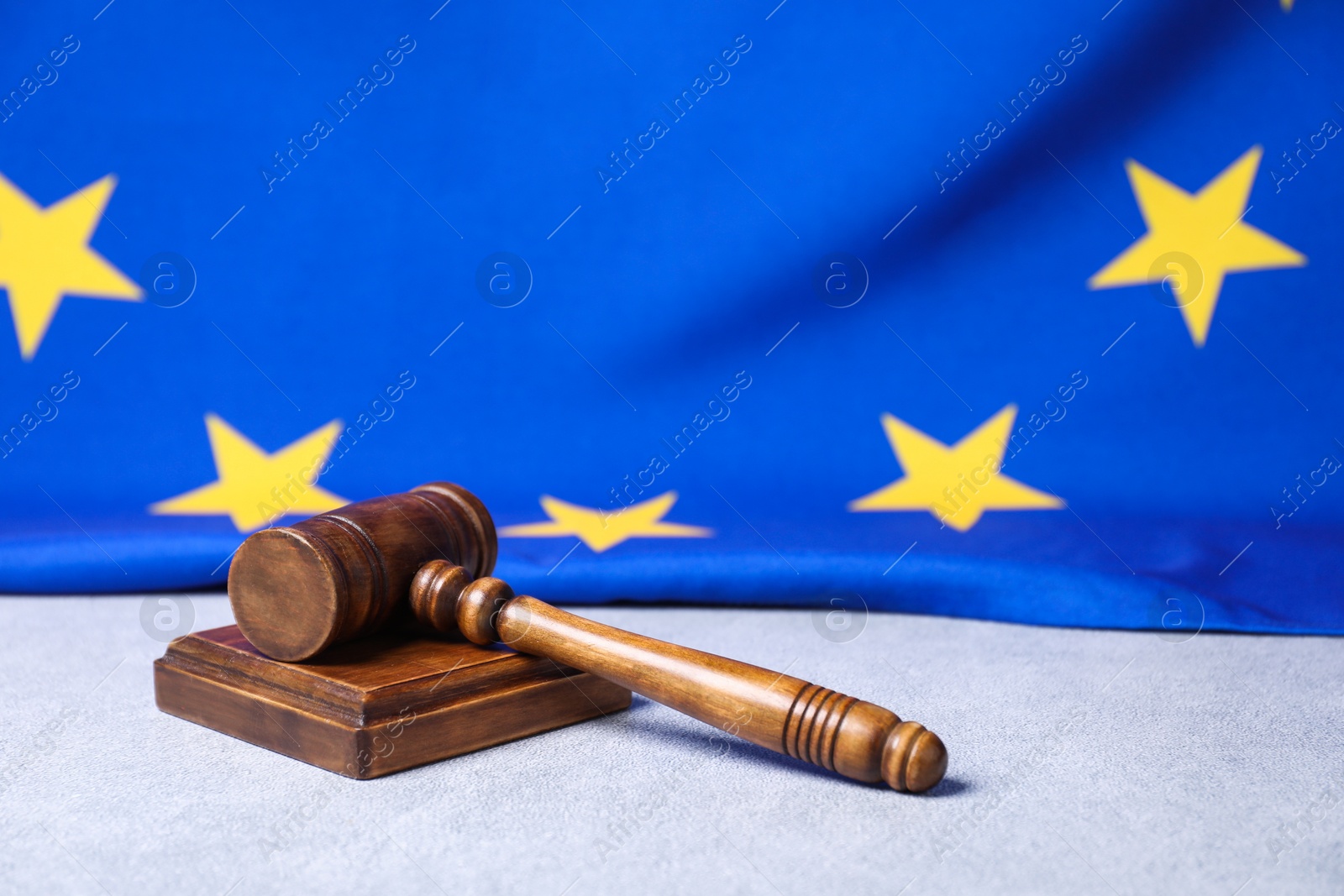 Photo of Judge's gavel and European Union flag on light grey table