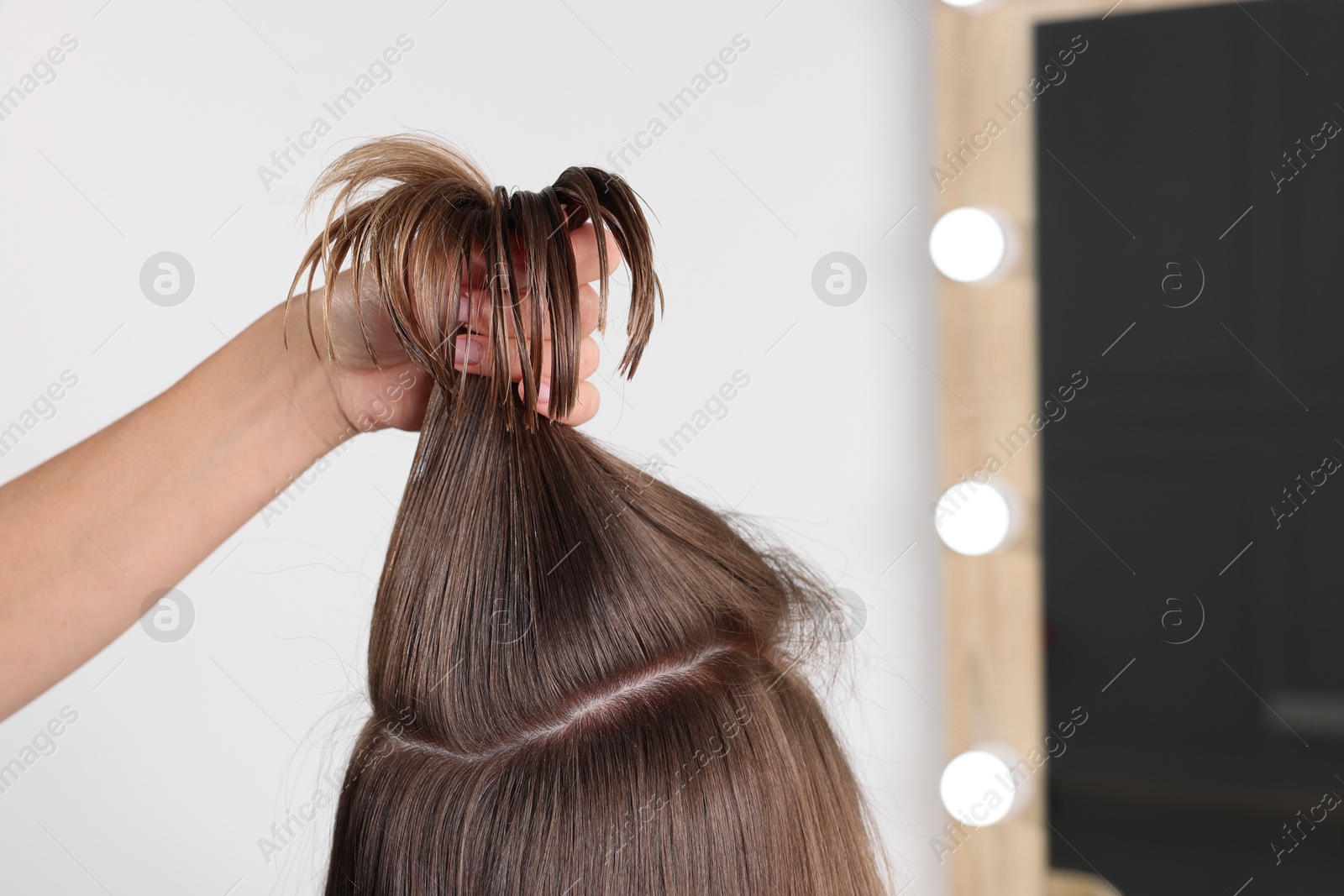 Photo of Hair cutting. Professional hairdresser working with client in salon, closeup