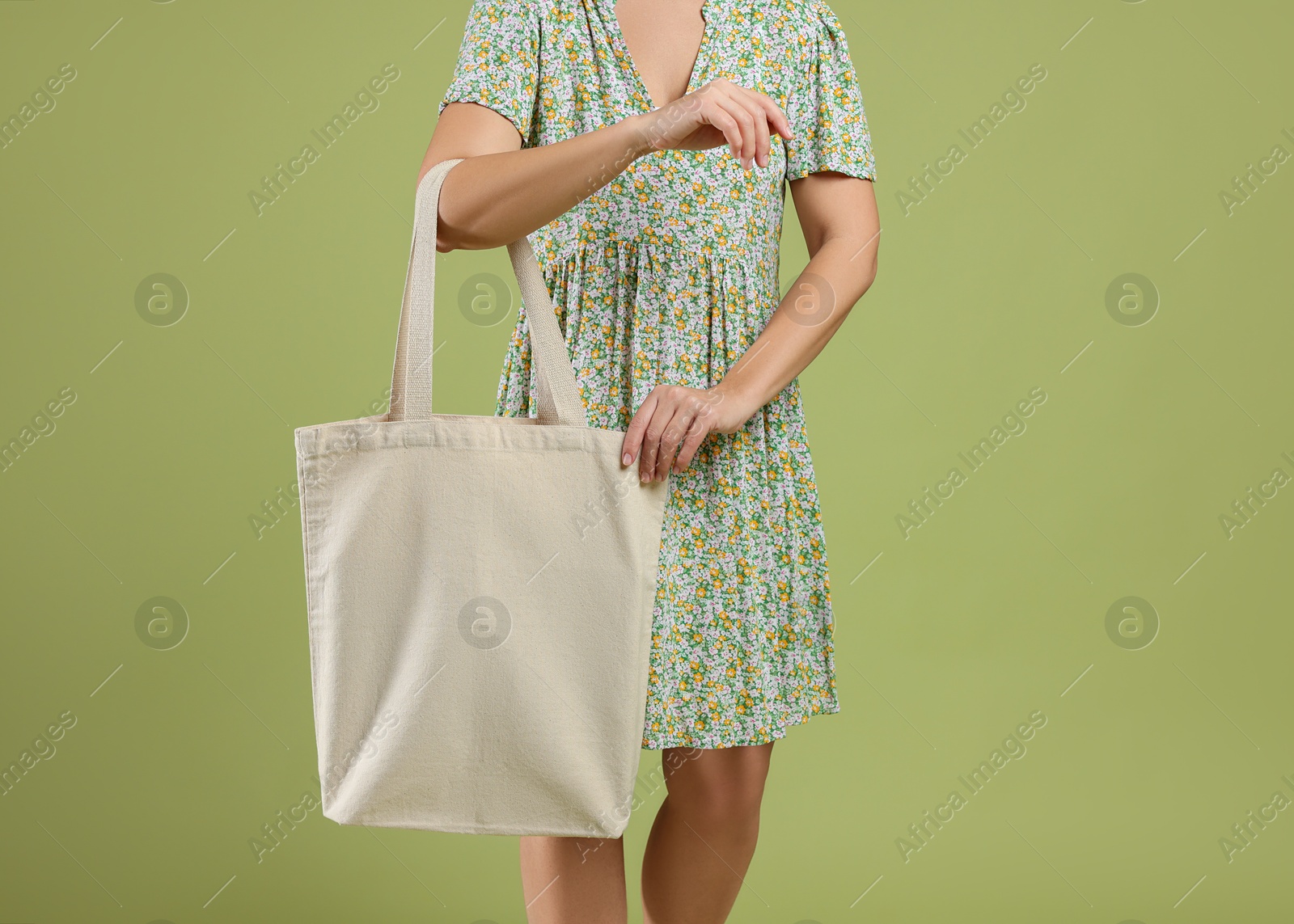 Photo of Woman with blank shopper bag on color background, closeup. Mockup for design