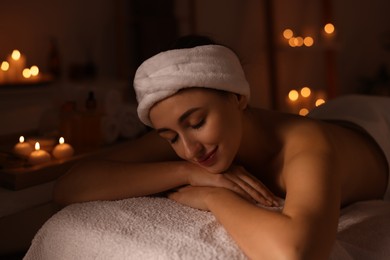 Photo of Young woman relaxing after massage in spa salon