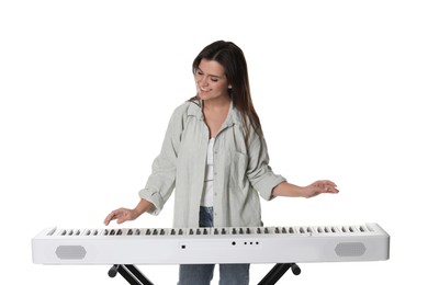 Photo of Smiling woman playing synthesizer on white background