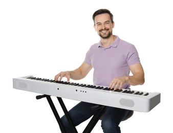 Photo of Smiling man playing synthesizer on white background