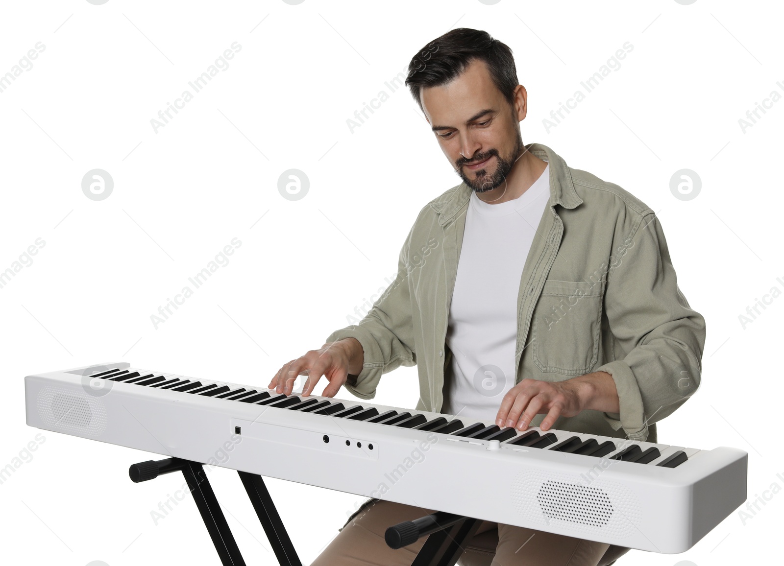 Photo of Bearded man playing synthesizer on white background