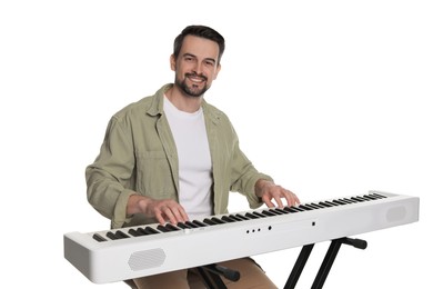 Photo of Smiling man playing synthesizer on white background