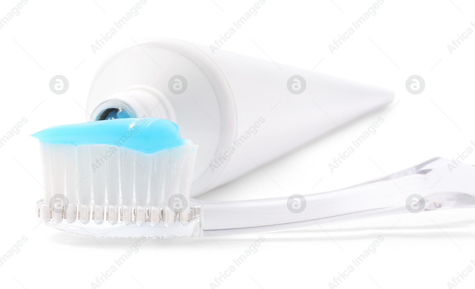 Photo of Toothbrush with toothpaste and tube isolated on white