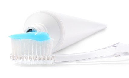 Photo of Toothbrush with toothpaste and tube isolated on white