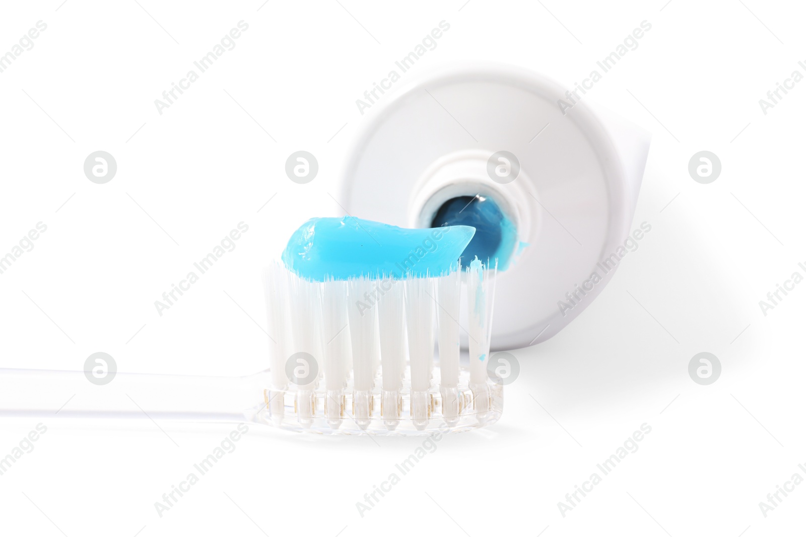 Photo of Toothbrush with toothpaste and tube isolated on white