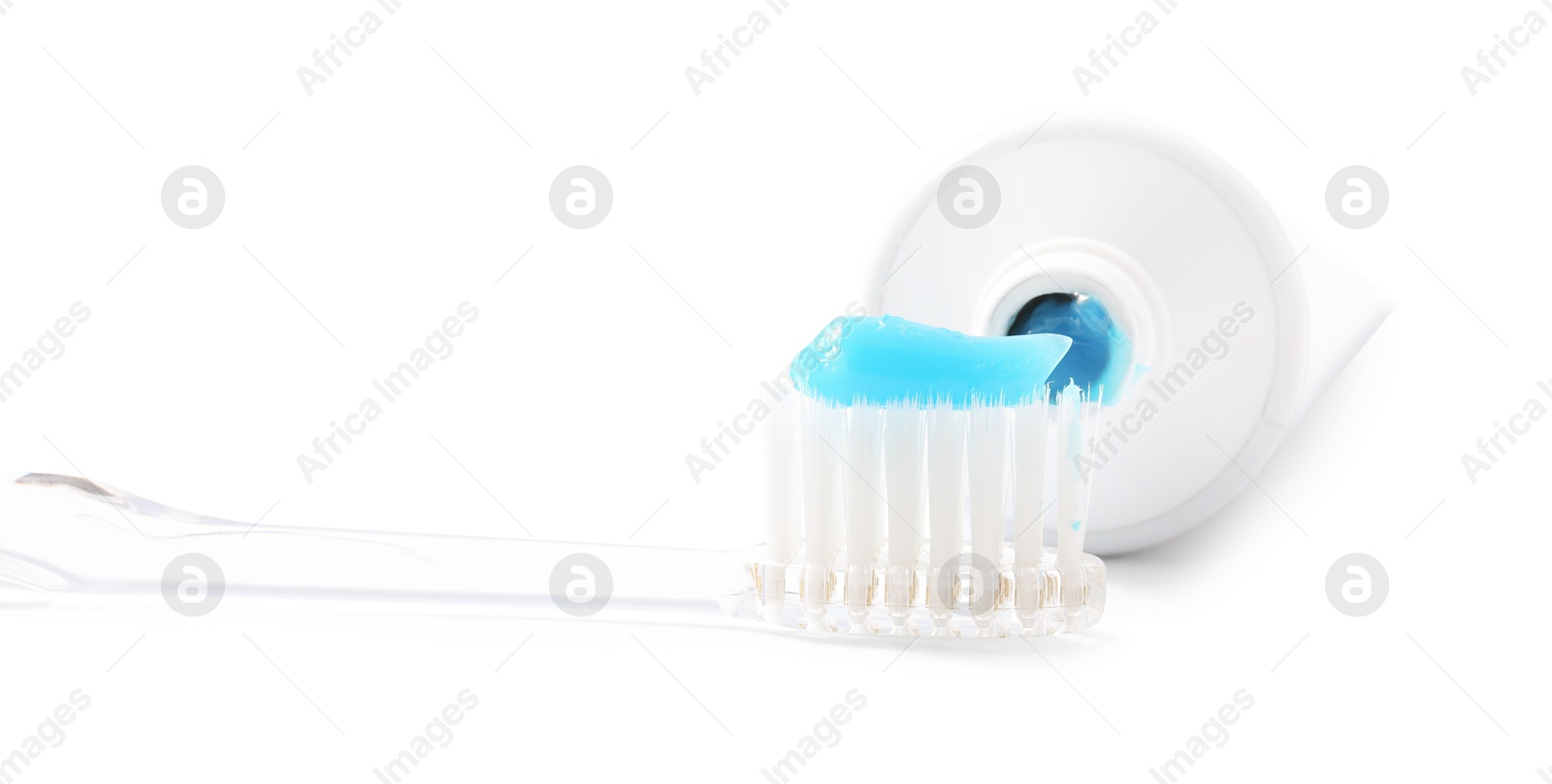 Photo of Toothbrush with toothpaste and tube isolated on white