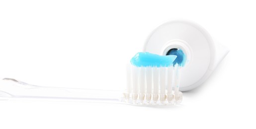 Photo of Toothbrush with toothpaste and tube isolated on white