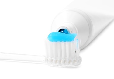 Photo of Toothbrush with toothpaste and tube isolated on white