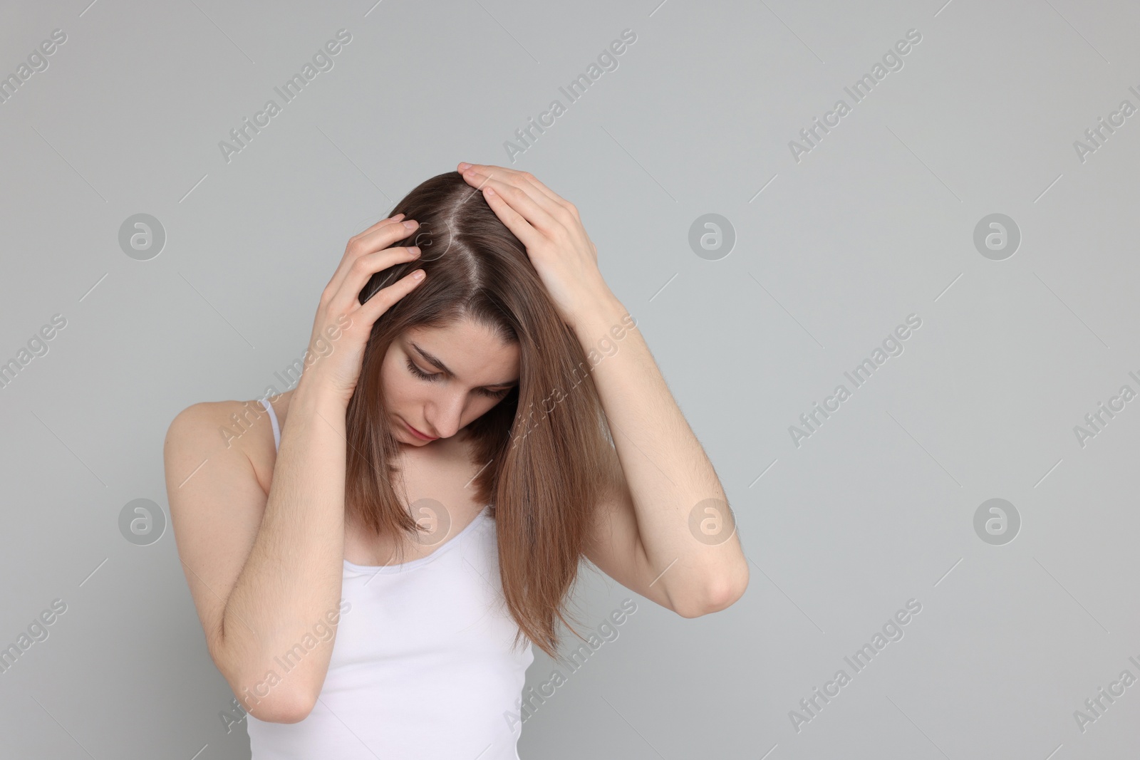 Photo of Girl with hair loss problem on grey background, space for text