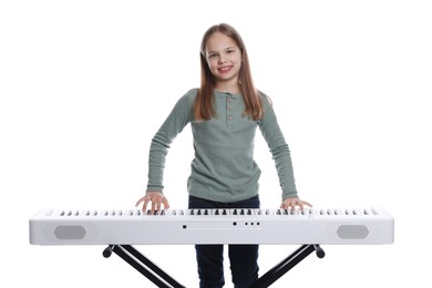 Photo of Cute girl playing synthesizer on white background