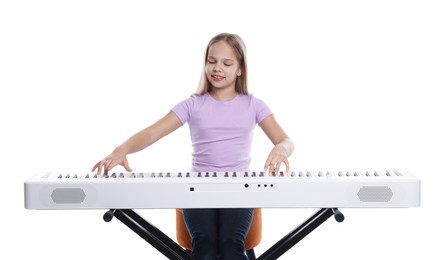 Photo of Cute girl playing synthesizer on white background