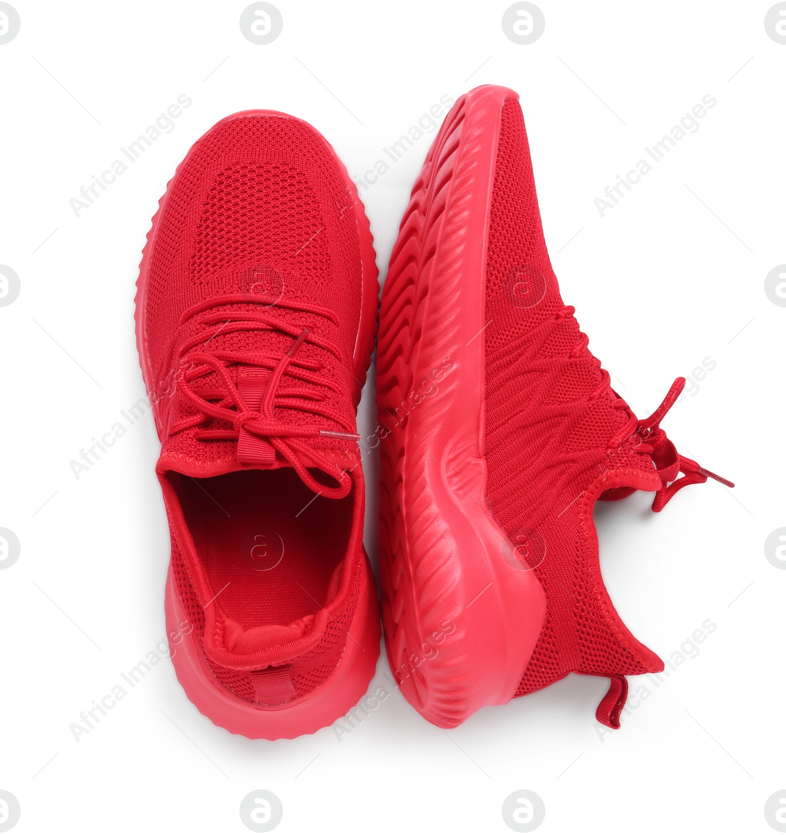 Photo of Pair of stylish red sneakers isolated on white, top view