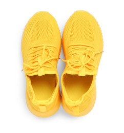 Photo of Pair of stylish yellow sneakers isolated on white, top view