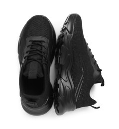 Photo of Pair of stylish black sneakers isolated on white, top view