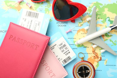 Photo of Flat lay composition with passports and tickets on world map