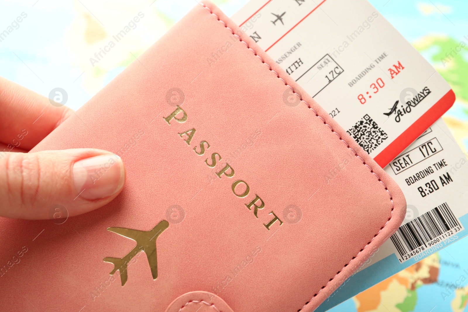 Photo of Person with passport and tickets on world map, closeup