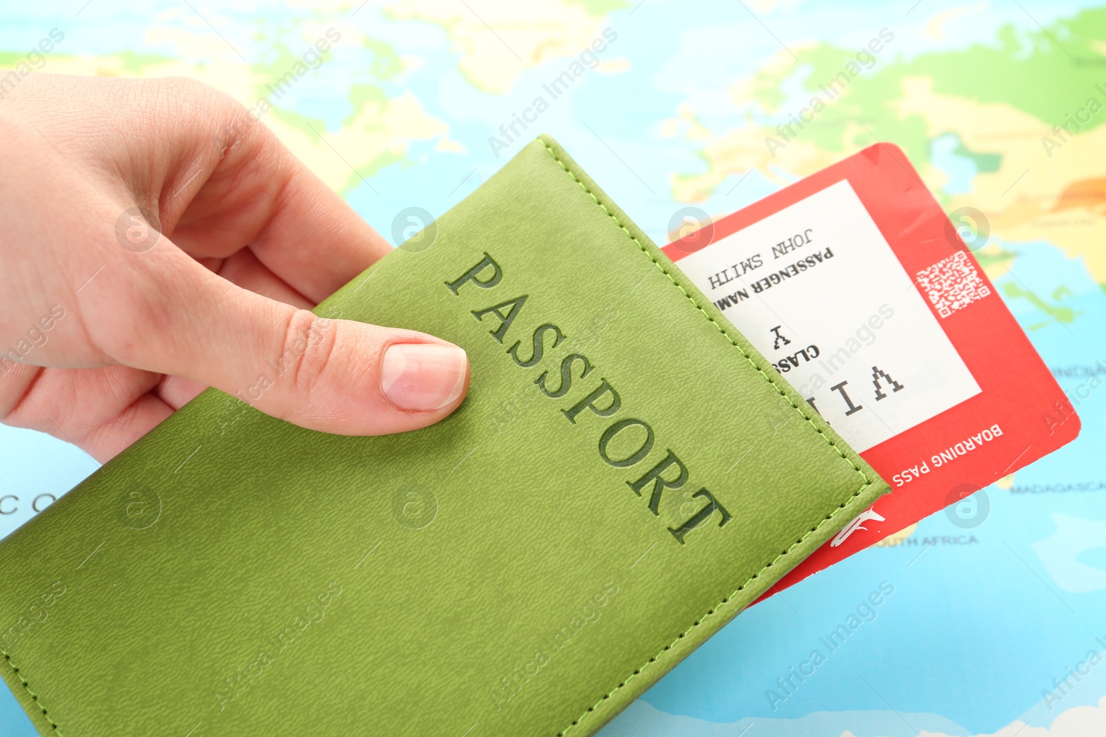 Photo of Person with passport and ticket on world map, closeup