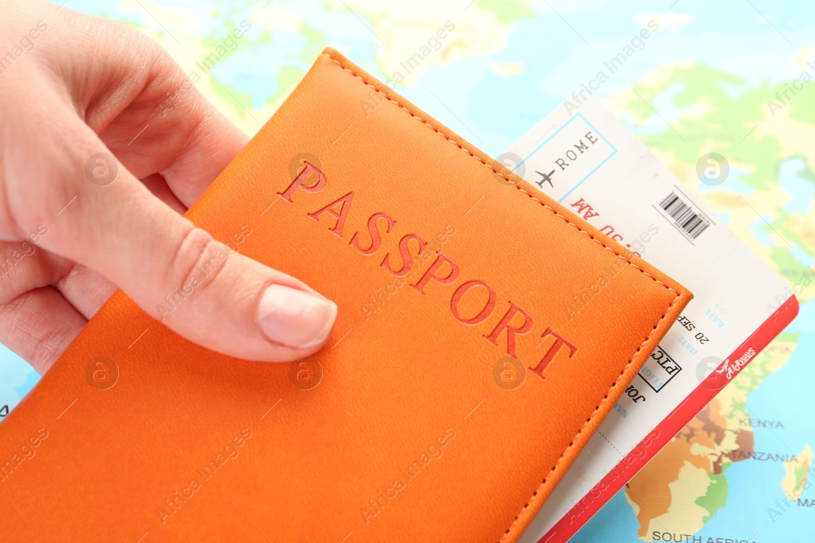 Photo of Person with passport and ticket on world map, closeup