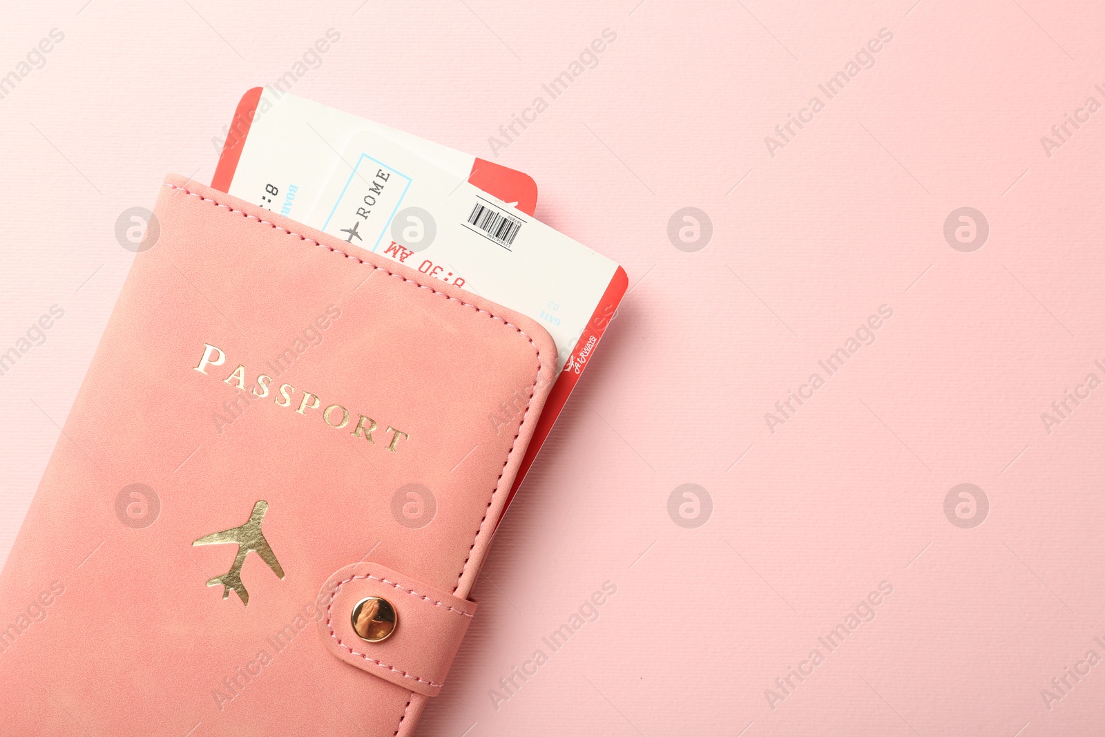 Photo of Passport with tickets on pink background, top view. Space for text