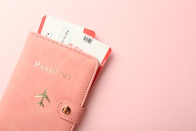 Photo of Passport with tickets on pink background, top view. Space for text