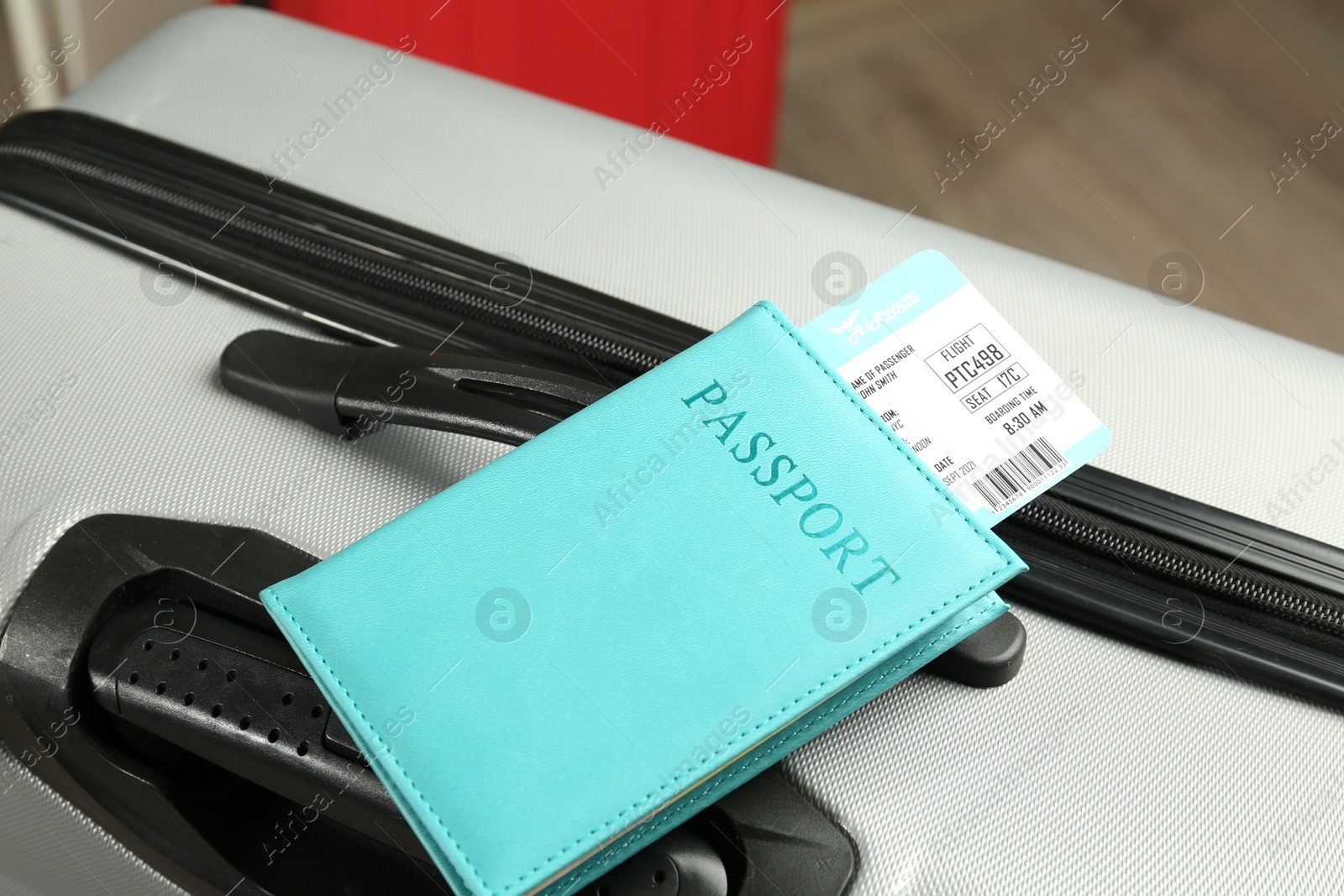 Photo of Passport with ticket on gray suitcase, closeup