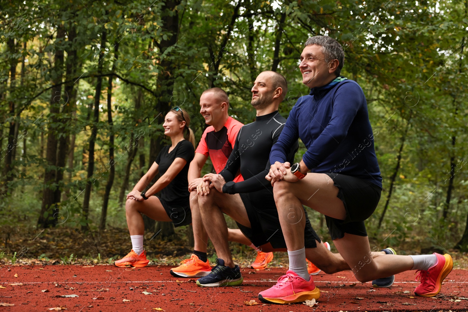 Photo of Group of people stretching in park. Healthy lifestyle