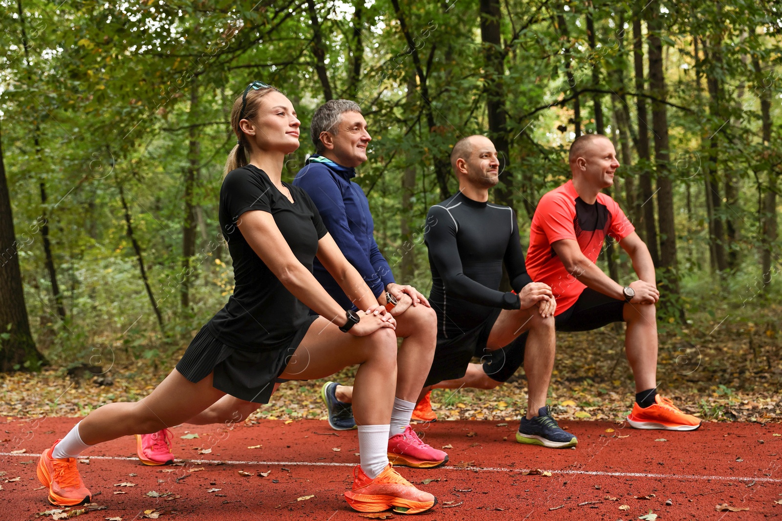 Photo of Group of people stretching in park. Healthy lifestyle