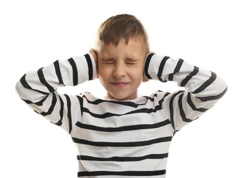 Photo of Little boy covering his ears on white background