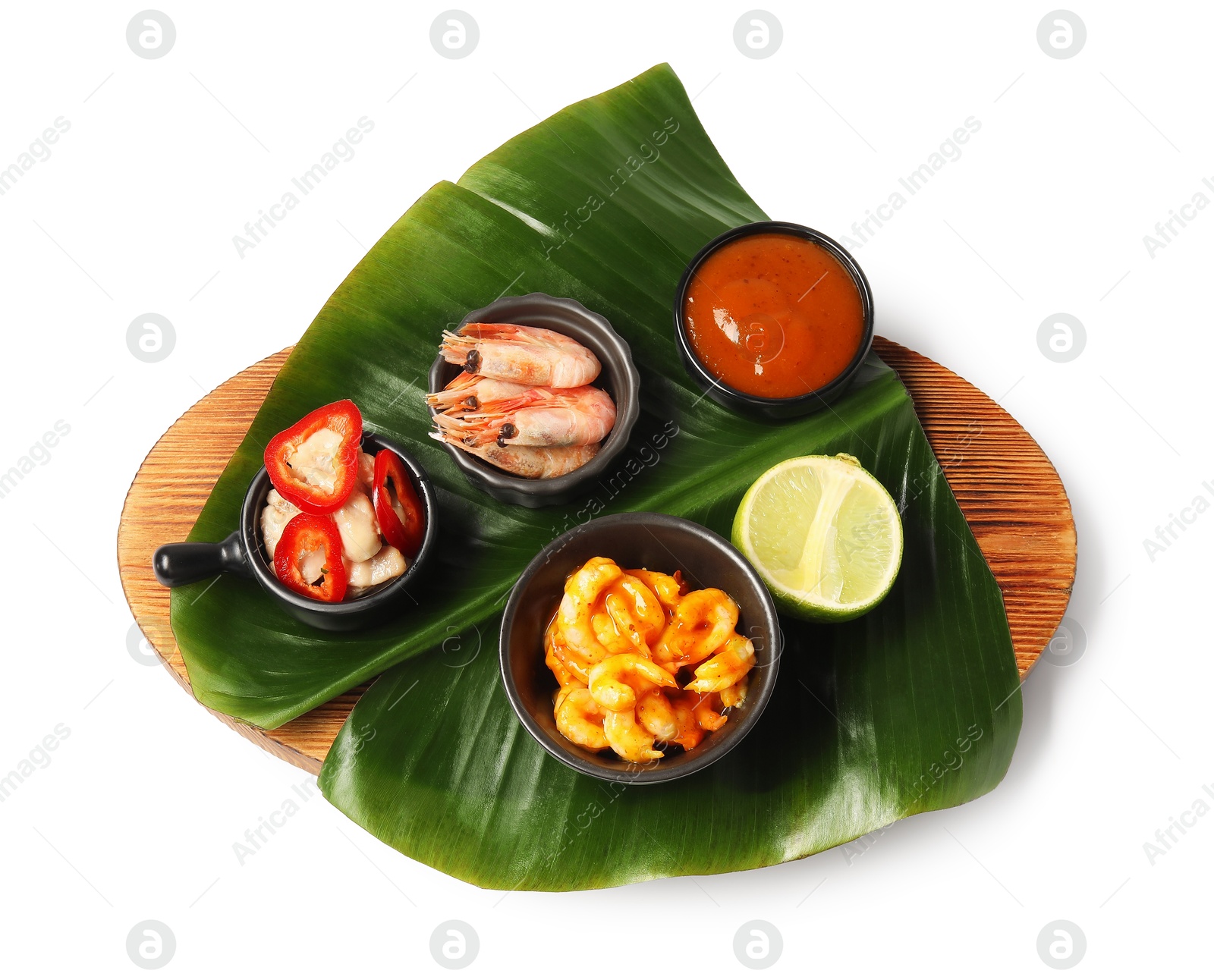 Photo of Cut banana leaf with different food and sauce isolated on white, top view. Healthy eco serving