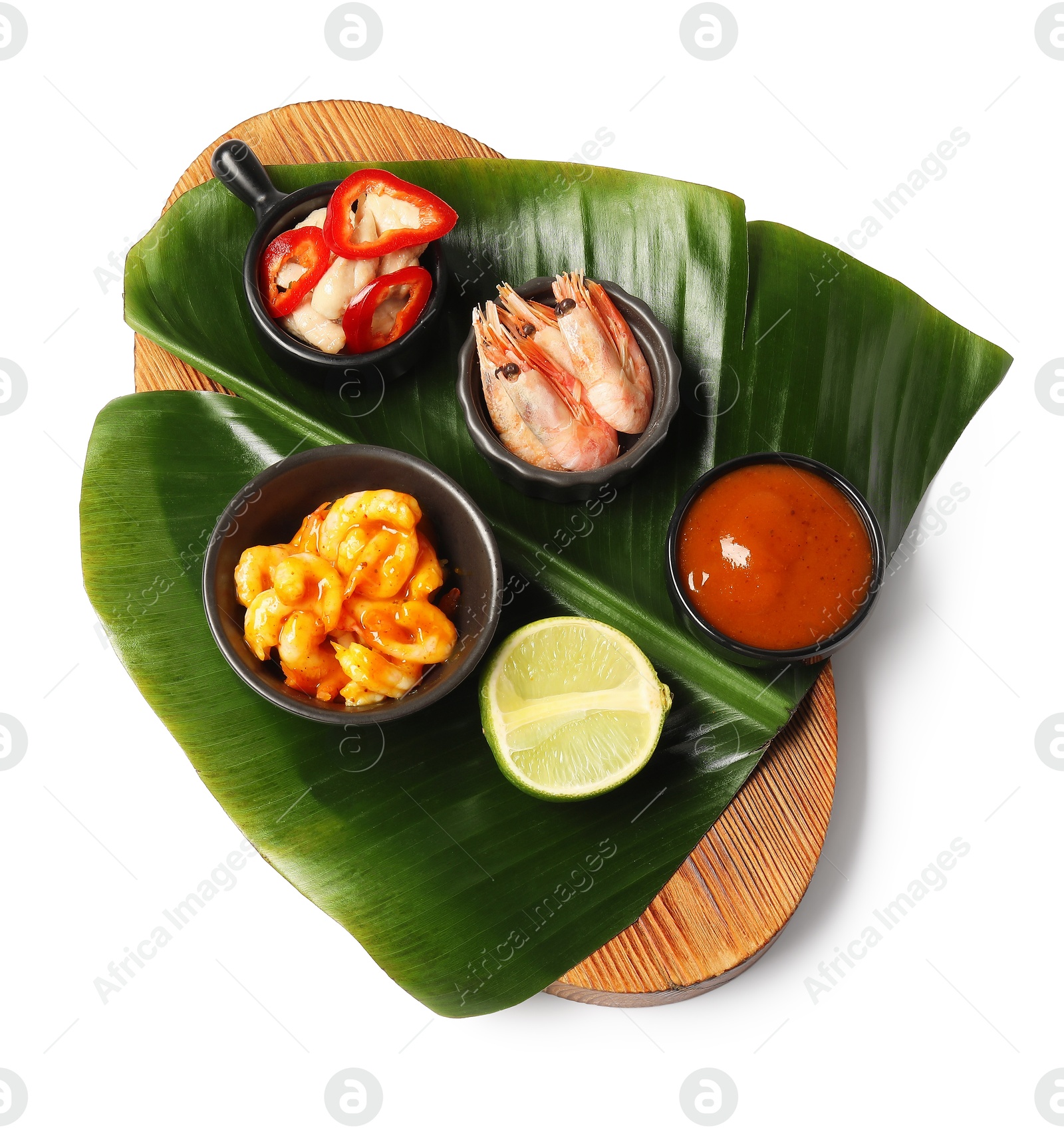 Photo of Cut banana leaf with different food and sauce isolated on white, top view. Healthy eco serving