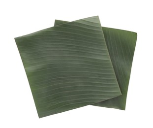 Photo of Pieces of banana leaves isolated on white, top view. Traditional meal serving