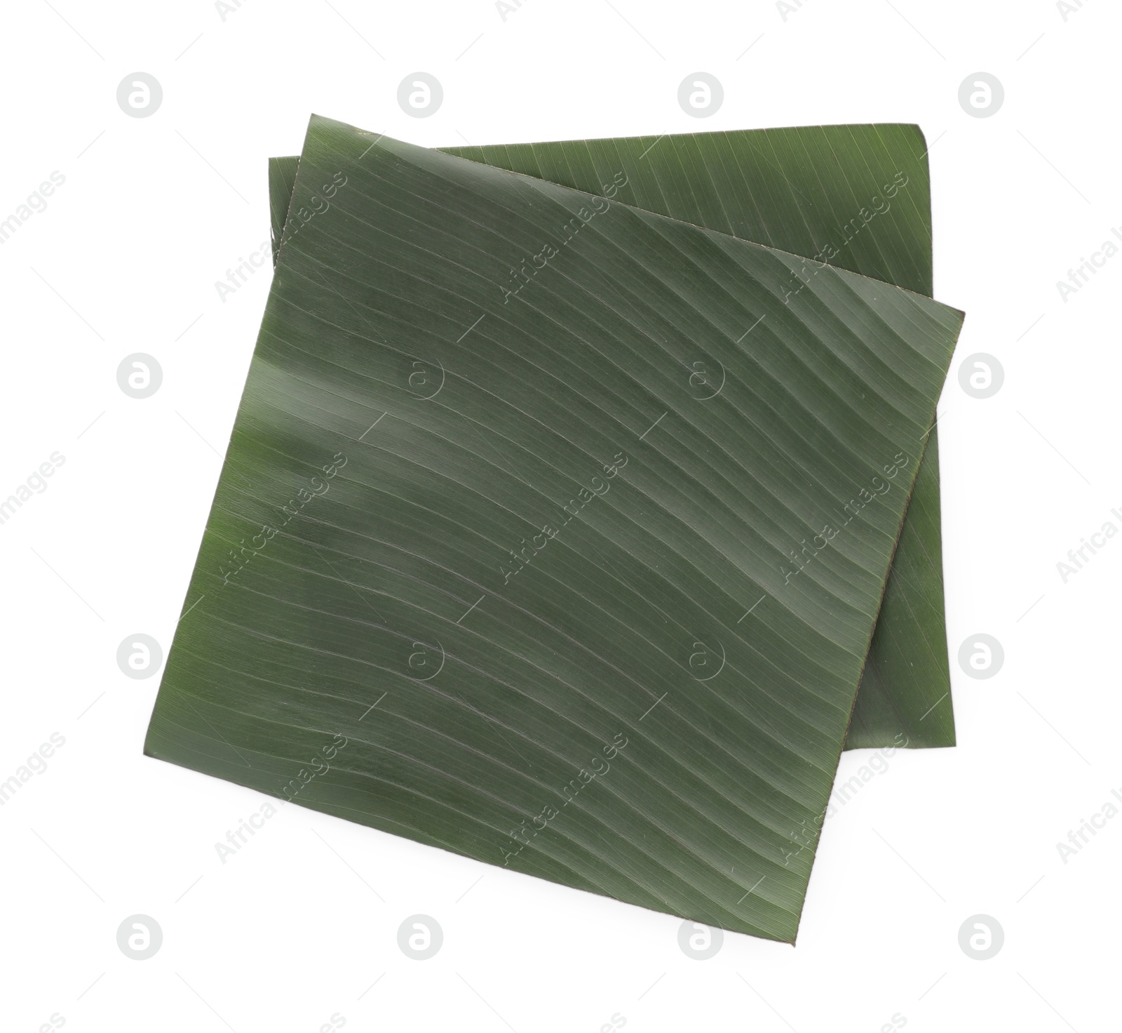 Photo of Pieces of banana leaves isolated on white, top view. Traditional meal serving