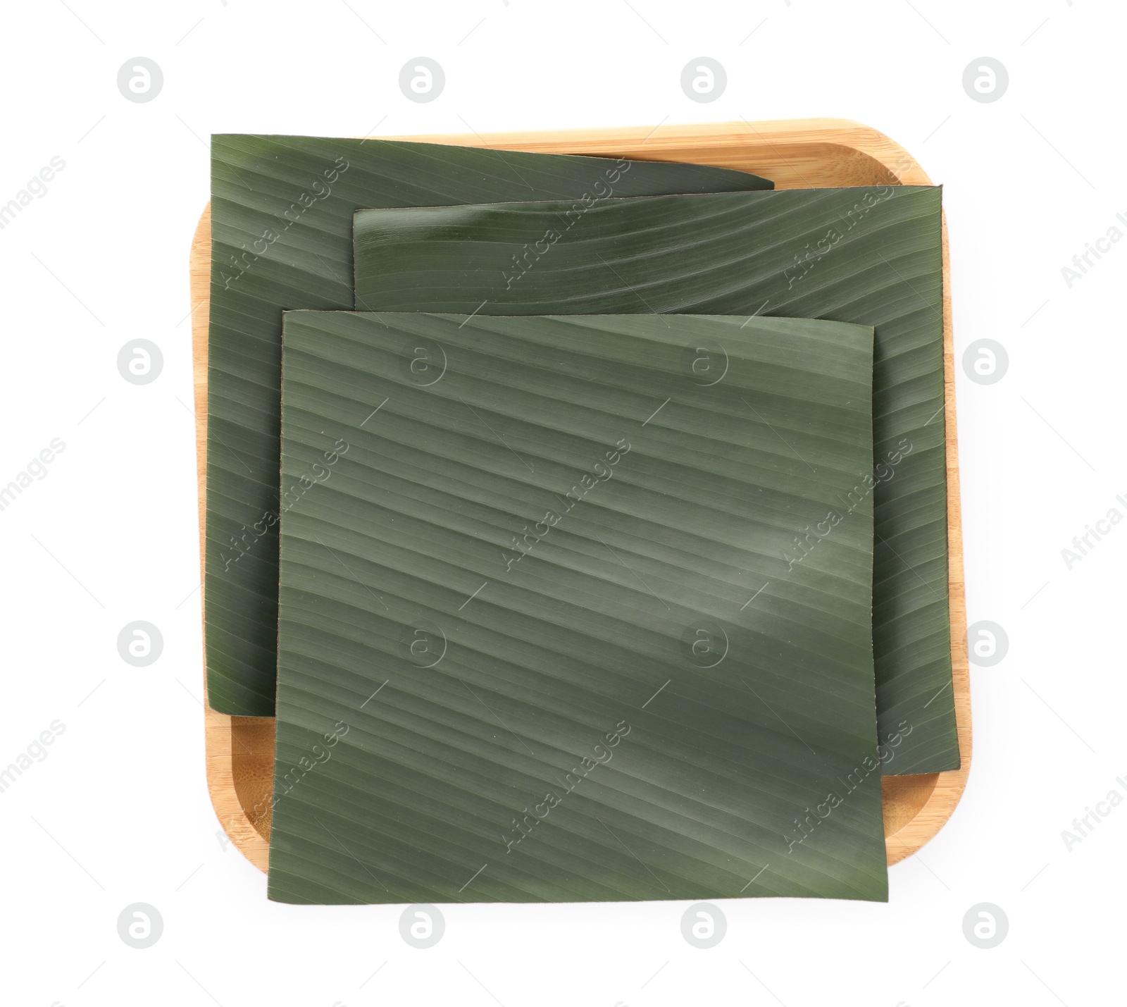 Photo of Pieces of banana leaves isolated on white, top view. Traditional meal serving