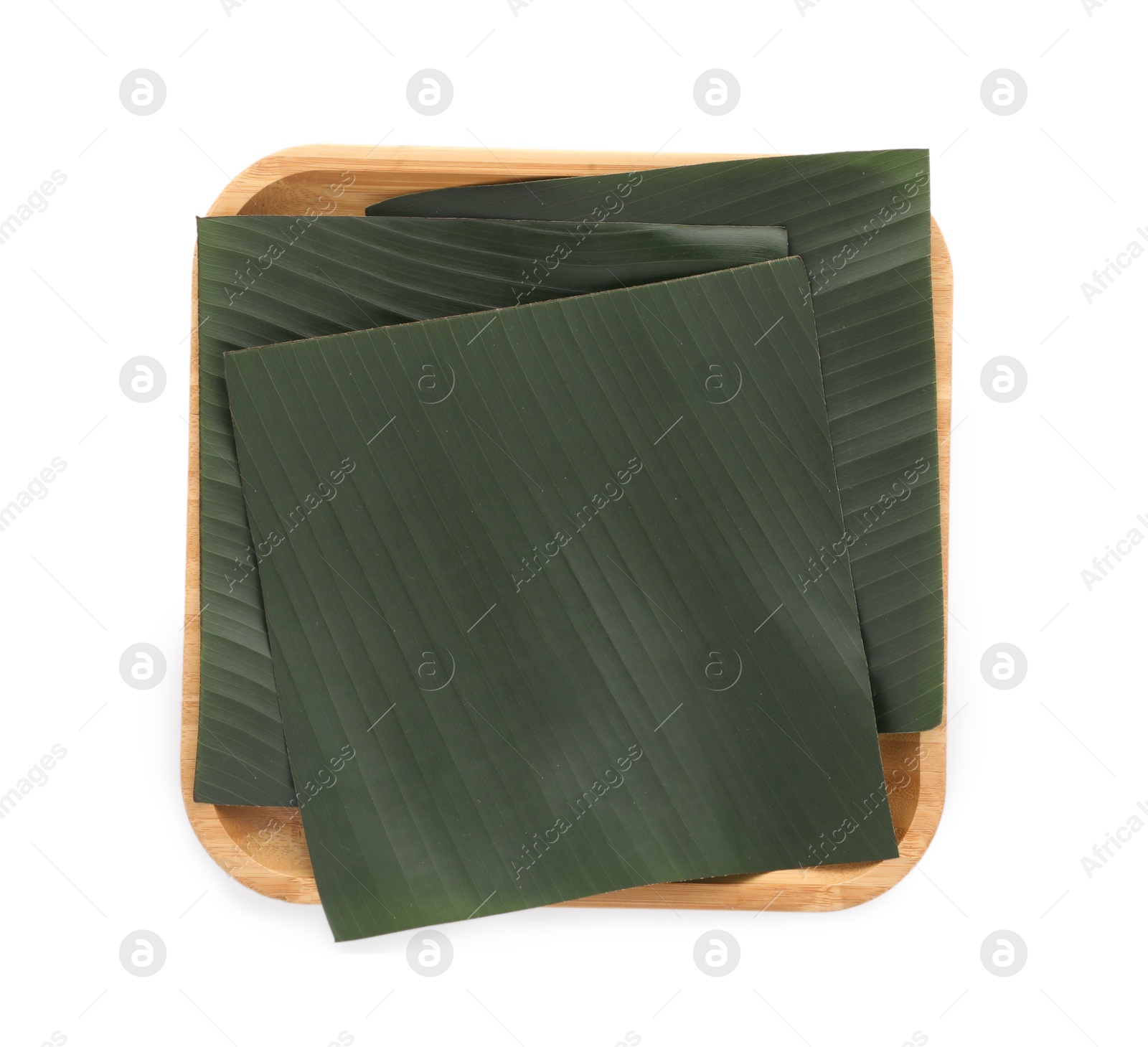 Photo of Pieces of banana leaves isolated on white, top view. Traditional meal serving