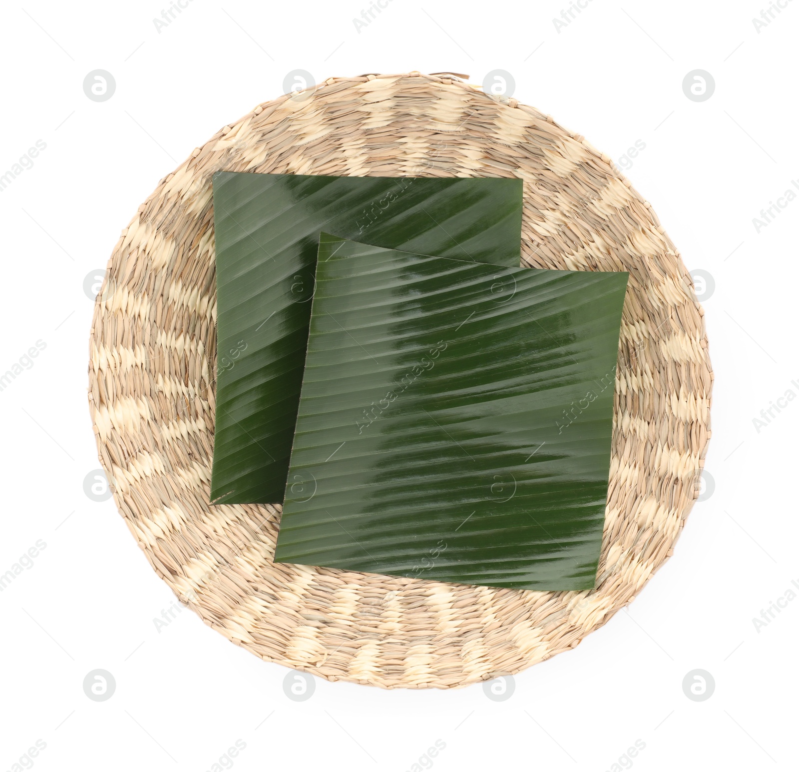 Photo of Pieces of banana leaves isolated on white, top view. Traditional meal serving