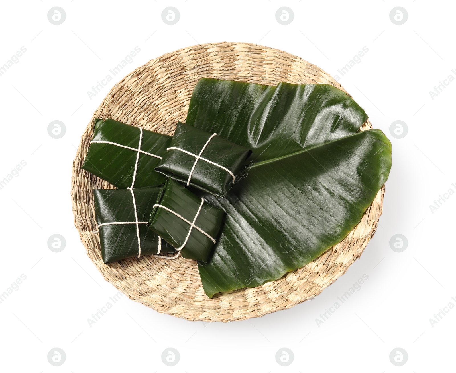 Photo of Cut banana leaves with food isolated on white, top view. Healthy eco serving