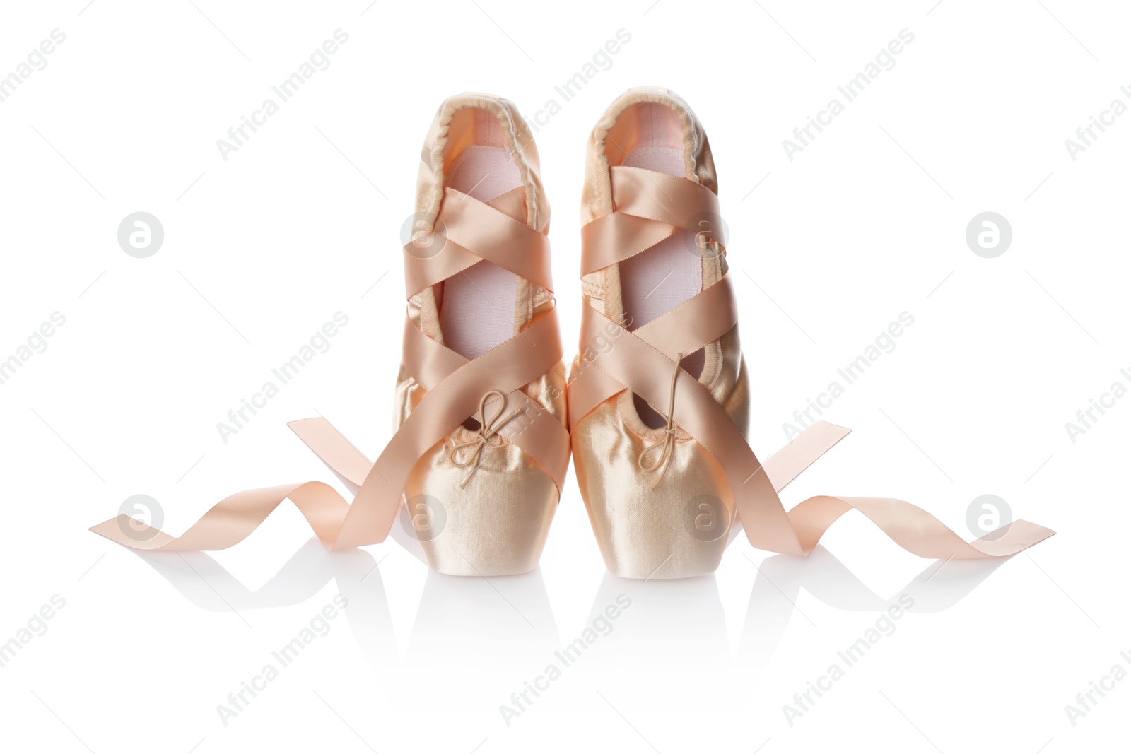 Photo of Pair of beautiful beige pointe shoes isolated on white