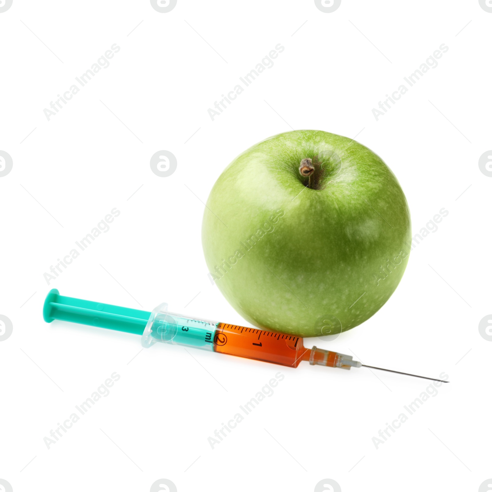 Photo of GMO concept. Green apple and syringe isolated on white