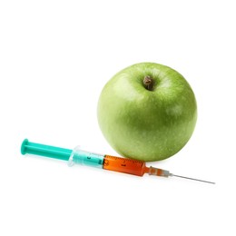 Photo of GMO concept. Green apple and syringe isolated on white