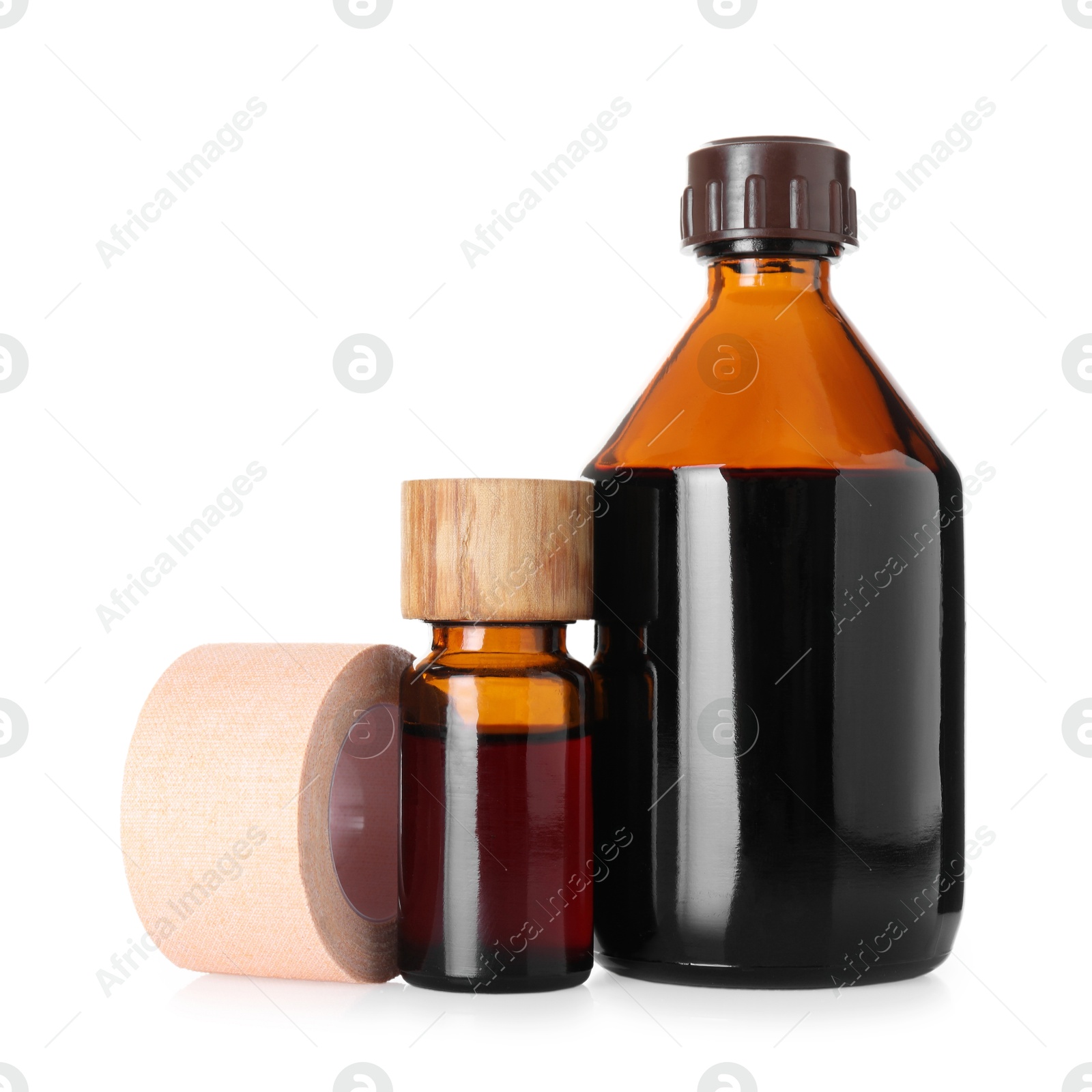 Photo of Bottles of topical iodine and adhesive bandage isolated on white