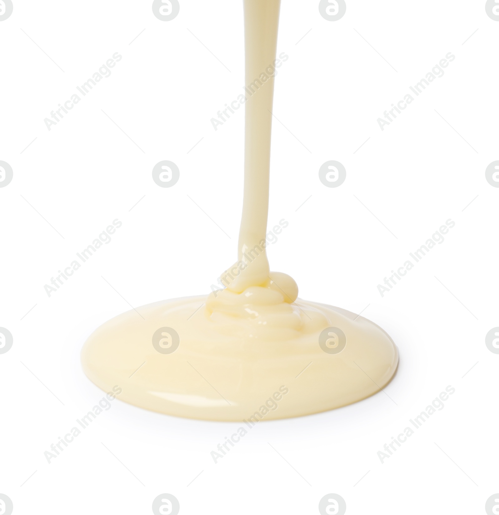 Photo of Pouring delicious condensed milk isolated on white