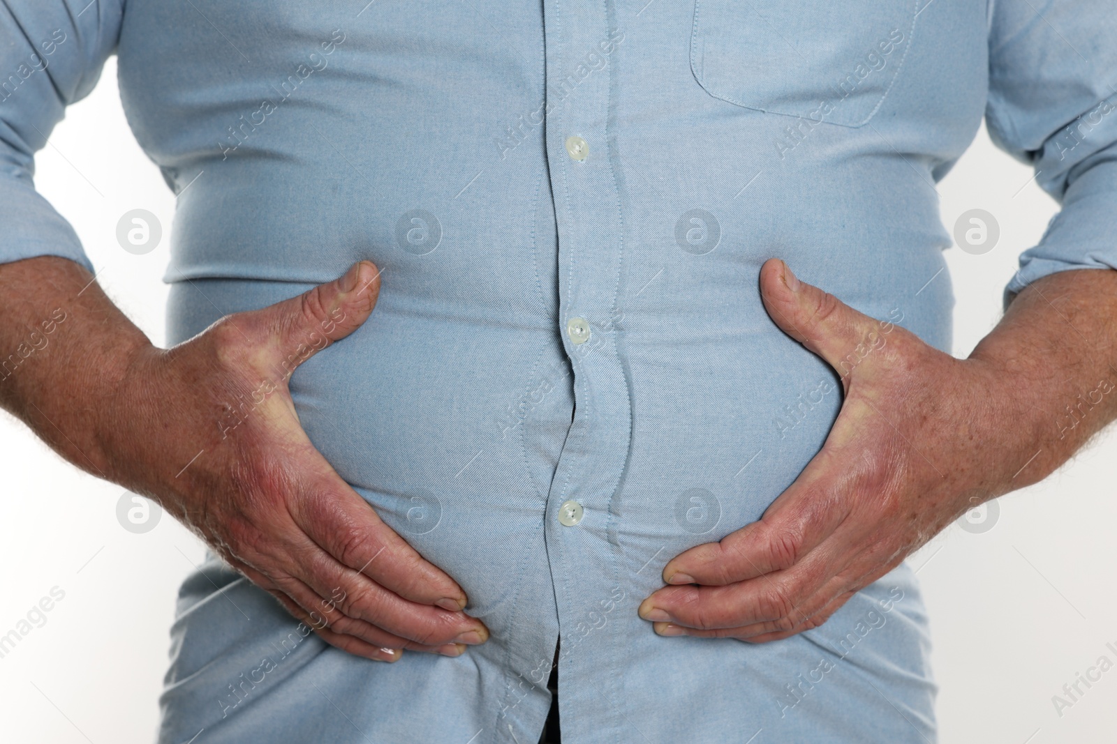 Photo of Overweight man in tight shirt on white background, closeup