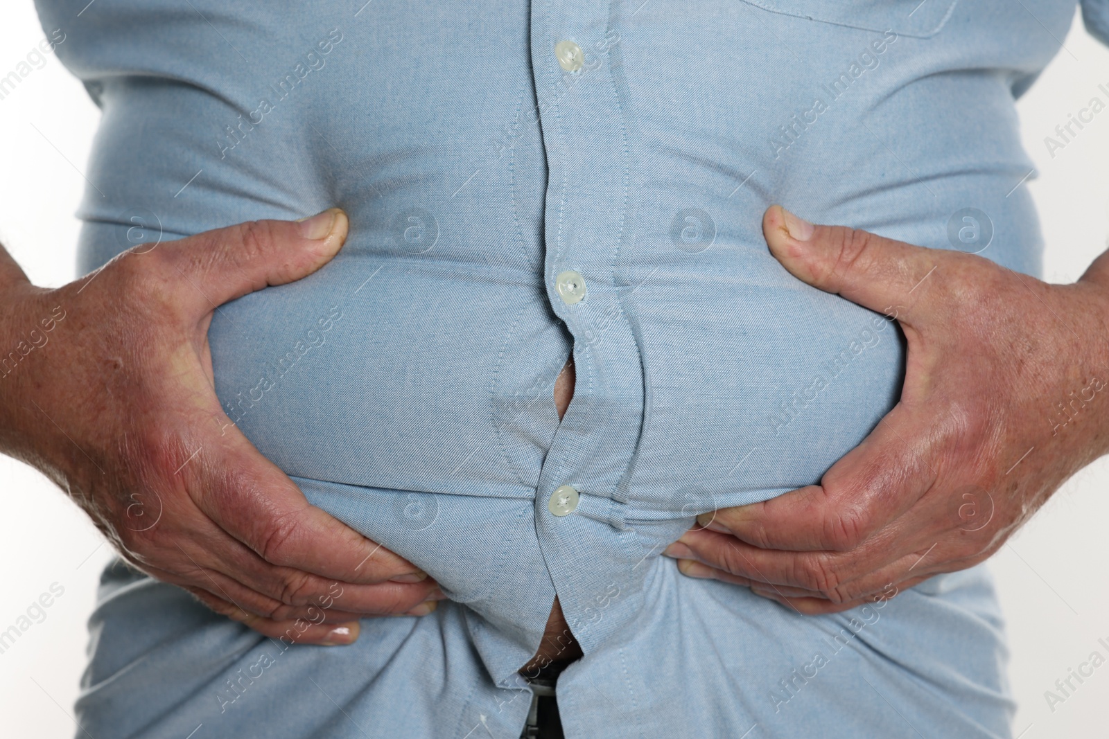 Photo of Overweight man in tight shirt on white background, closeup