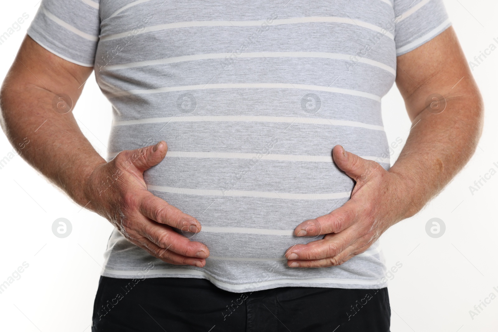 Photo of Overweight man in tight t-shirt on white background, closeup