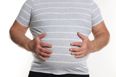 Photo of Overweight man in tight t-shirt on white background, closeup