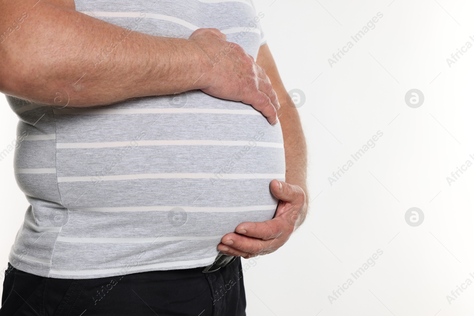 Photo of Overweight man in tight t-shirt on white background, closeup. Space for text